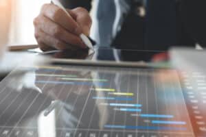 Image of a man creating a poam schedule using online software.
