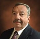 Man in black suit smiling