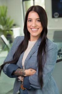 Lauren De Leon, Project Manager at Alluvionic, smiling in a professional office headshot.