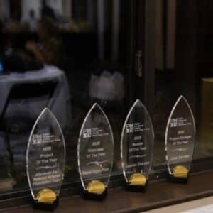 Glass PMI Space Coast Chapter awards lined up, displaying multiple 2025 Project Management Institute honors.